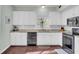 Modern kitchen with granite countertops, white cabinets, and stainless steel appliances at 1600 Windsor Ln, Moncks Corner, SC 29461