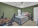 Green bedroom with a queen bed, workspace, and ceiling fan at 1600 Windsor Ln, Moncks Corner, SC 29461