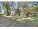 Large backyard with a grassy area, trees, and wooden fence at 1600 Windsor Ln, Moncks Corner, SC 29461