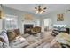 L-shaped sofa, fireplace, hardwood floors, and access to kitchen at 1600 Windsor Ln, Moncks Corner, SC 29461