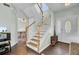 Elegant staircase with wooden steps and white railings at 1600 Windsor Ln, Moncks Corner, SC 29461