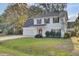 Two-story white house with gray roof, red door, and attached garage at 1600 Windsor Ln, Moncks Corner, SC 29461