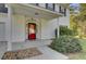 Red front door with glass accents, white columns and stone pathway at 1600 Windsor Ln, Moncks Corner, SC 29461