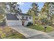Two-story white house with gray roof, red door, and attached garage at 1600 Windsor Ln, Moncks Corner, SC 29461