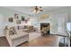 L-shaped sofa, fireplace, hardwood floors, and access to kitchen at 1600 Windsor Ln, Moncks Corner, SC 29461