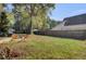 Large backyard with wooden fence, grass, and mature trees at 1600 Windsor Ln, Moncks Corner, SC 29461