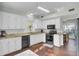 Modern kitchen with granite countertops, white cabinets, and stainless steel appliances at 1600 Windsor Ln, Moncks Corner, SC 29461