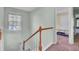 Upstairs hallway with carpet, a window, and doors to bedrooms at 1600 Windsor Ln, Moncks Corner, SC 29461