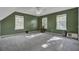 Spacious bedroom with gray carpet, three windows, and a cat tree at 1600 Windsor Ln, Moncks Corner, SC 29461