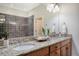 Spa-like bathroom with double vanity, granite countertops, and dark tile shower at 235 Cooper River Dr, Mount Pleasant, SC 29464