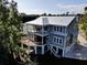 Two-story house with a metal roof, deck, and screened porch at 1999 N Creek Dr, Mount Pleasant, SC 29466