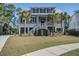 Two-story house with a metal roof and palm trees in front at 1999 N Creek Dr, Mount Pleasant, SC 29466