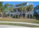 Two-story house with a metal roof and palm trees in front at 1999 N Creek Dr, Mount Pleasant, SC 29466