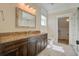 Bathroom with granite countertop, dark brown vanity and marble tile floor at 1999 N Creek Dr, Mount Pleasant, SC 29466