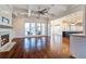 Open living room with a fireplace, built-ins, hardwood floors, and access to a porch at 1999 N Creek Dr, Mount Pleasant, SC 29466