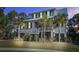 Two-story home with a metal roof, and palm trees in the front yard at 1999 N Creek Dr, Mount Pleasant, SC 29466