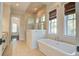 Spa-like bathroom with a soaking tub, walk-in shower, and tile floors at 1999 N Creek Dr, Mount Pleasant, SC 29466