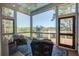 Screened porch with comfy seating and marsh views at 1999 N Creek Dr, Mount Pleasant, SC 29466