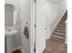 Clean bathroom with pedestal sink and access to hallway and stairs at 728 Ladywood Dr, Summerville, SC 29486