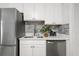 Modern kitchen with white cabinets, stainless steel appliances, and a quartz countertop at 2150 Spoleto Ln # H7, North Charleston, SC 29406