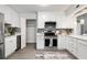 Modern kitchen with white cabinets, stainless steel appliances, and a quartz countertop at 2150 Spoleto Ln # H7, North Charleston, SC 29406