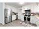 Modern kitchen with white cabinets, stainless steel appliances, and a quartz countertop at 2150 Spoleto Ln # H7, North Charleston, SC 29406