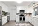 Modern kitchen with white cabinets, stainless steel appliances, and a quartz countertop at 2150 Spoleto Ln # H7, North Charleston, SC 29406