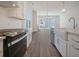 Modern kitchen with farmhouse sink and stainless steel appliances at 321 Trailmore Ln, Summerville, SC 29486