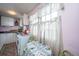 Cozy kitchen with white cabinets and a small dining area at 64 Radcliffe St, Charleston, SC 29403