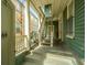 Front porch with white columns and wooden stairs at 64 Radcliffe St, Charleston, SC 29403