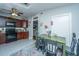 Eat in kitchen with dark wood cabinets, granite counters, and a green table at 64 Radcliffe St, Charleston, SC 29403