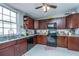 Well-equipped kitchen with dark wood cabinets, granite countertops, and stainless steel appliances at 64 Radcliffe St, Charleston, SC 29403