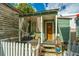 Quaint cottage with porch, wooden steps and white picket fence at 64 Radcliffe St, Charleston, SC 29403