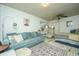 Open living room with light teal couch and whitewashed floors at 64 Radcliffe St, Charleston, SC 29403