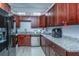 Well-equipped kitchen with dark wood cabinets and granite counters at 64 Radcliffe St, Charleston, SC 29403