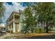 Charming two-story green house with a white porch at 64 Radcliffe St, Charleston, SC 29403