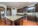 Modern kitchen with dark wood cabinets, granite countertops and island at 551 Rosings Dr, Summerville, SC 29486