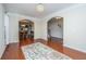 Bright living room with hardwood floors, arched doorways, and views to the dining room and staircase at 551 Rosings Dr, Summerville, SC 29486