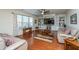 Relaxing living room featuring hardwood floors, built-in shelving, and neutral-toned furniture at 551 Rosings Dr, Summerville, SC 29486
