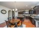 Kitchen with island, dark wood cabinets, granite countertops, and stainless steel appliances at 551 Rosings Dr, Summerville, SC 29486