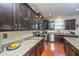 Modern kitchen with dark wood cabinets, granite countertops, and stainless steel appliances at 551 Rosings Dr, Summerville, SC 29486