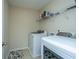 Bright laundry room with washer, dryer, and shelving at 551 Rosings Dr, Summerville, SC 29486