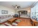 Living room with hardwood floors, ceiling fan, and view into the kitchen at 551 Rosings Dr, Summerville, SC 29486
