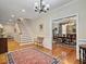 Elegant entryway with hardwood floors, a chandelier, and views of the dining room and staircase at 102 Flud St, Summerville, SC 29483