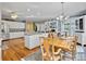 Open concept kitchen and dining area with stainless steel appliances and hardwood floors at 102 Flud St, Summerville, SC 29483