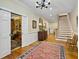 Bright entryway with hardwood floors, a chandelier, and views to the dining room and staircase at 102 Flud St, Summerville, SC 29483