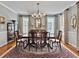 Spacious dining room with hardwood floors, large windows, and a formal dining set at 102 Flud St, Summerville, SC 29483