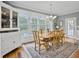Bright dining room features hardwood floors, a wood table with six chairs, and a large window at 102 Flud St, Summerville, SC 29483