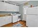 Bright laundry room with white cabinets, washer, dryer, and additional storage at 102 Flud St, Summerville, SC 29483