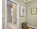 Bathroom with a walk-in shower, a linen cabinet, and a large mirror at 102 Flud St, Summerville, SC 29483